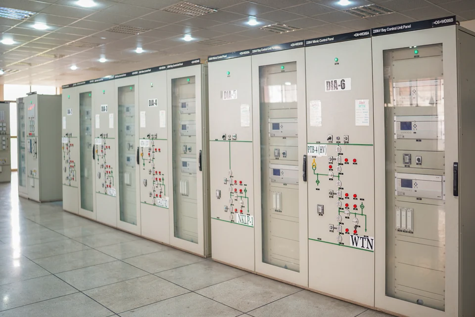 Control cabinets arranged along a bright equipment room